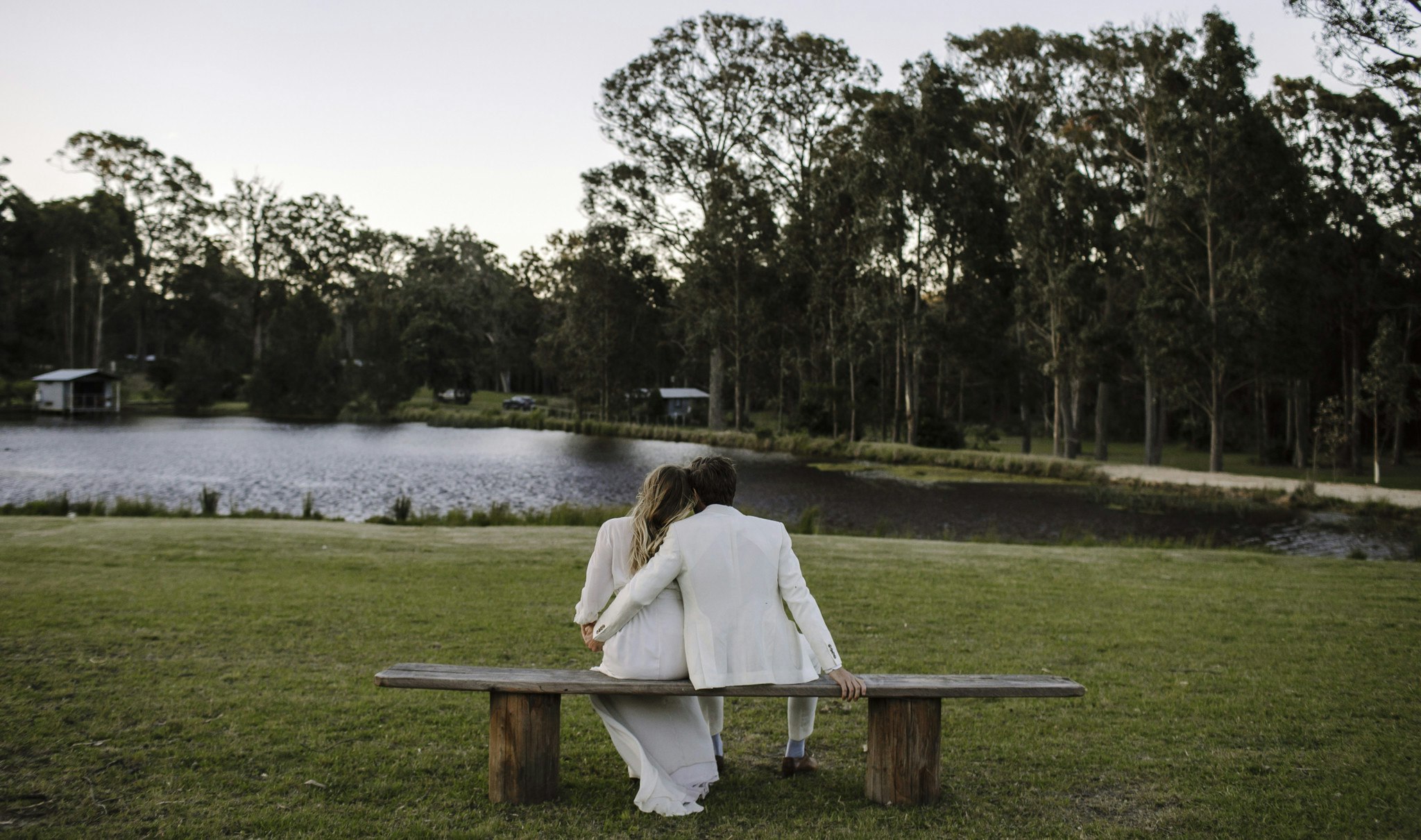 Wedding couple overlooking a lake.